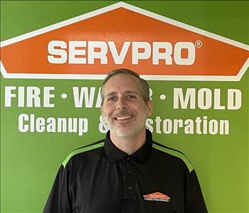 Photo of man in front of Servpro logo