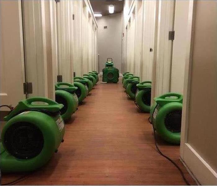 Air movers placed in a long hallway of a store